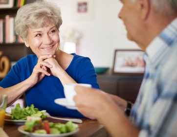 seniors sitting at a table having a conversation over a meal