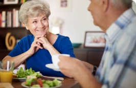 seniors sitting at a table having a conversation over a meal