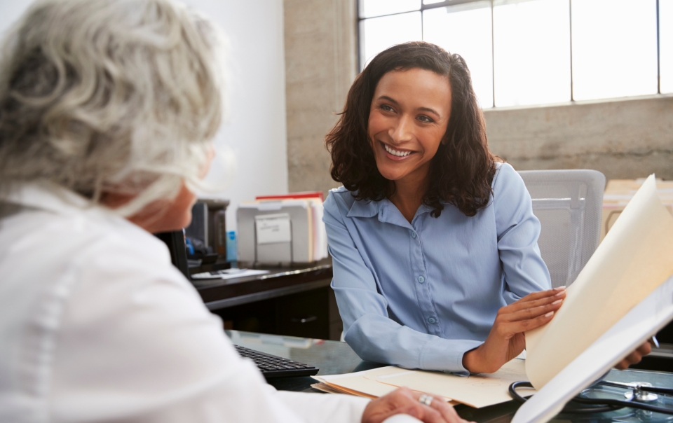 Woman Professional showing client paperwork