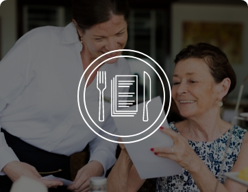 woman ordering from menu to waiter